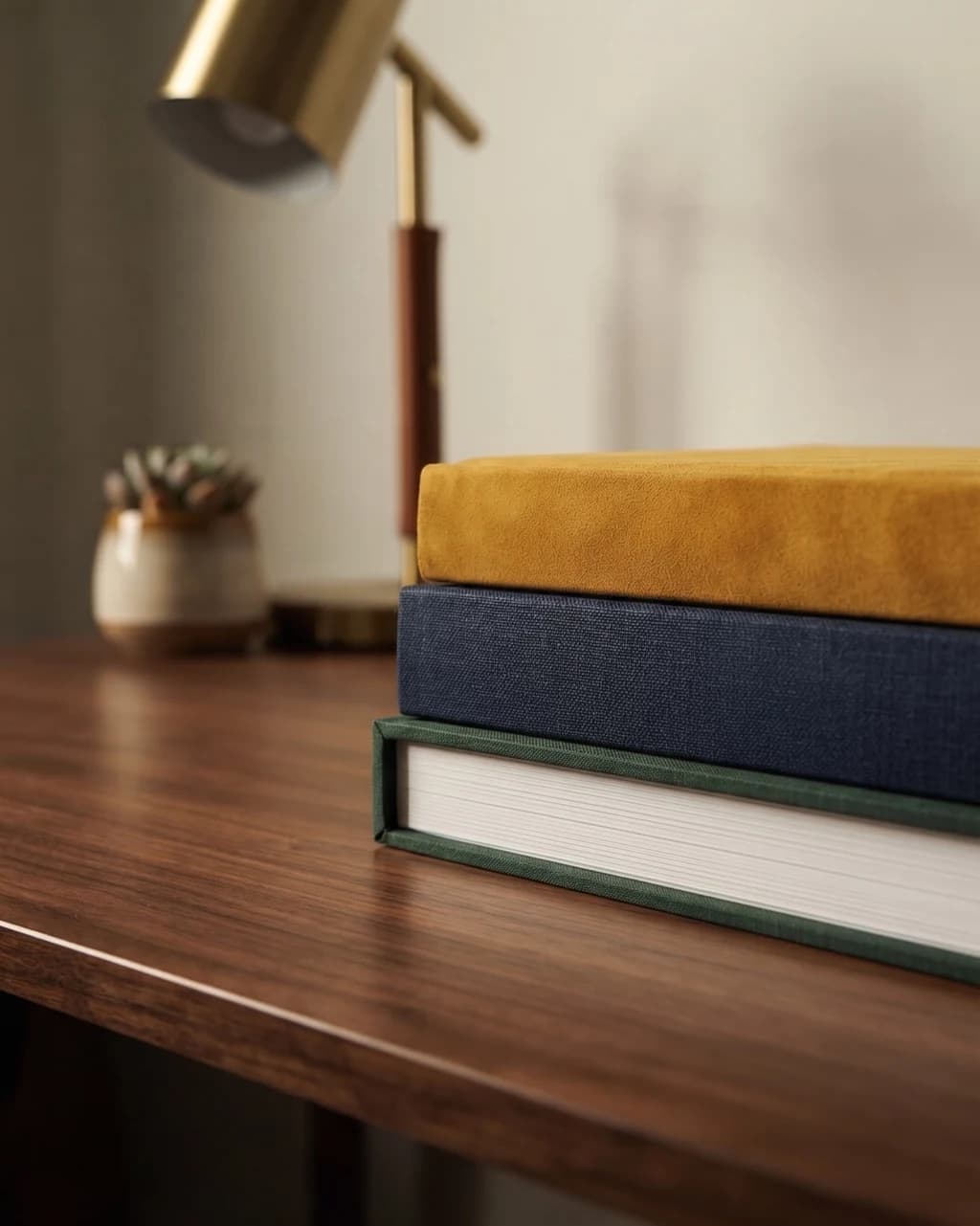 Custom leather heirloom photo album with gold embossing on a dark table