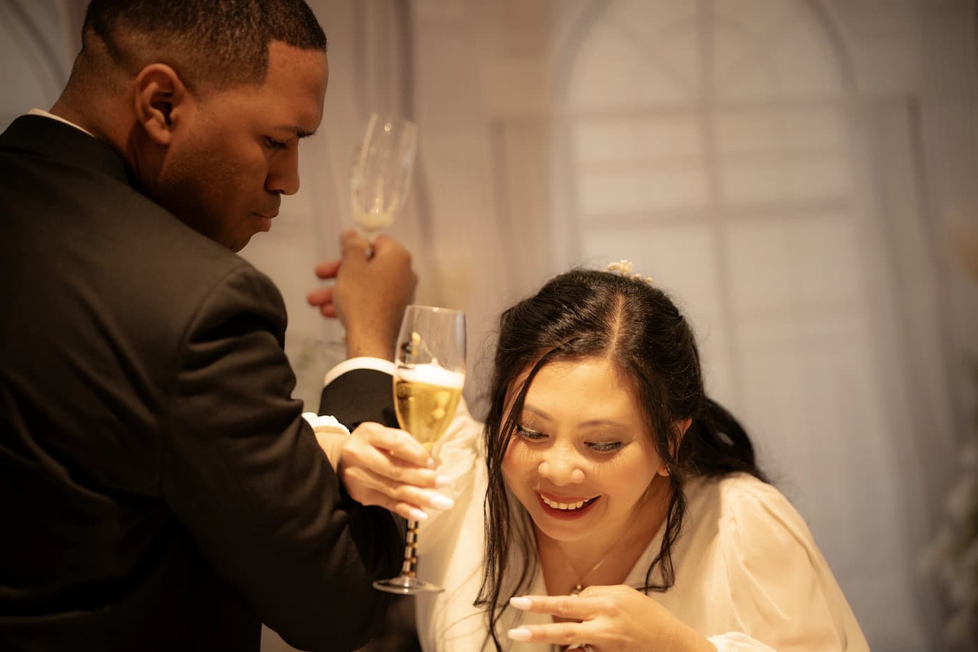 Father giving a toast as guests laugh and raise their glasses